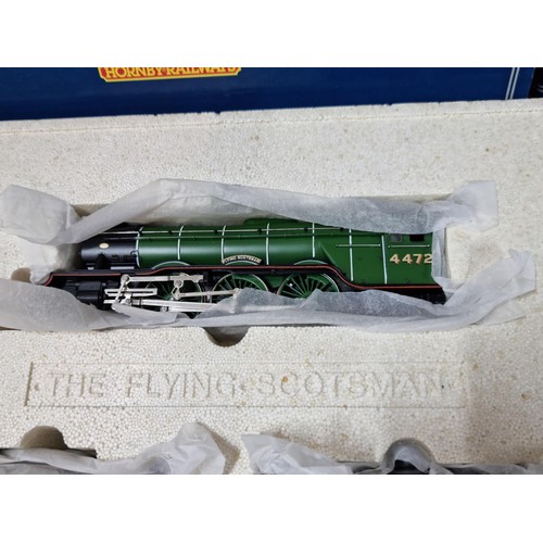 96 - A comprehensive boxed as new Hornby Flying Scotsman locomotive set R098 and R089 to include a flying... 