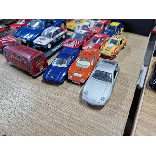 106 - A large collection of 18x various diecast model cars, mostly of racing sports cars by various makers... 