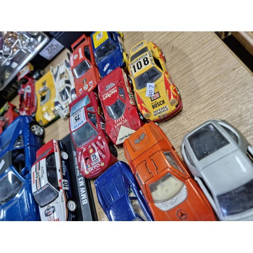 106 - A large collection of 18x various diecast model cars, mostly of racing sports cars by various makers... 