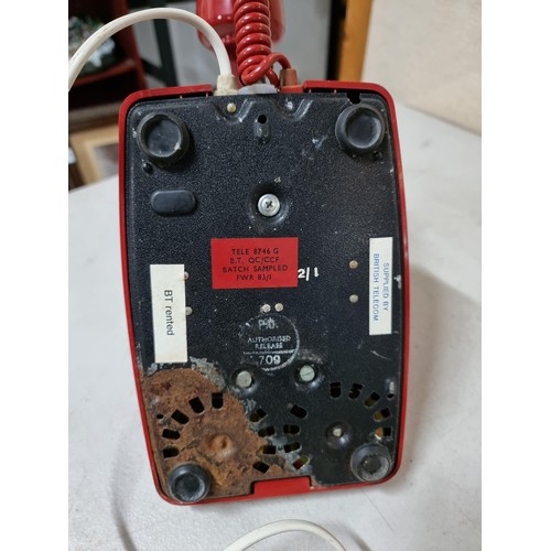 30 - A converted vintage red rotary dial telephone stamped P.O. Authorized release 701 underneath (tele 8... 