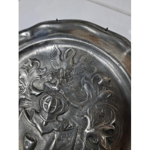 31 - A vintage Rein Zinn pewter plate with an embossed coat or arms, in good overall condition. Has a dia... 