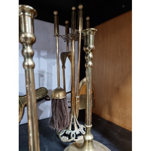 46 - A large quantity of metalware to include 4 pairs of brass candlesticks, 2 chrome silver plated cande... 