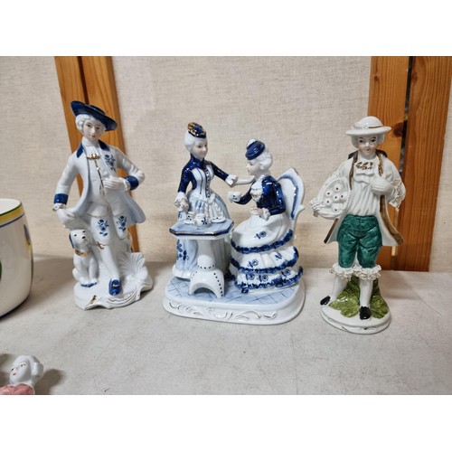 49 - A collection of 6 porcelain figures along with a good quality tall conical glazed vase in brown and ... 