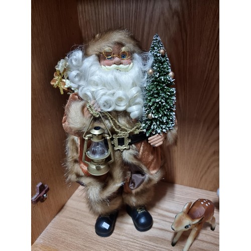 51 - An ornate Santa Claus figure holding a lantern along with a similar Mrs Claus and 2 vintage early pl... 