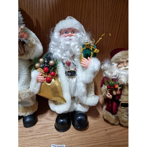 53 - A collection of 3x Santa figures, 2 which are battery operated. All in good order, tallest figure ha... 