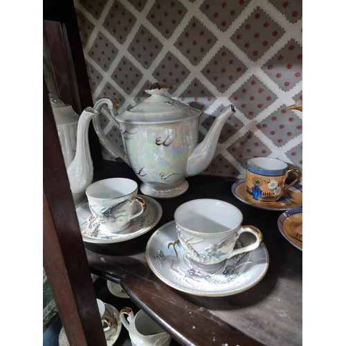 1 - A collection of 4x part oriental tea sets including a mother of pearl lustre tea set, a dragon desig... 