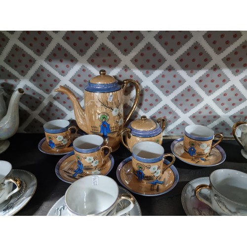 1 - A collection of 4x part oriental tea sets including a mother of pearl lustre tea set, a dragon desig... 