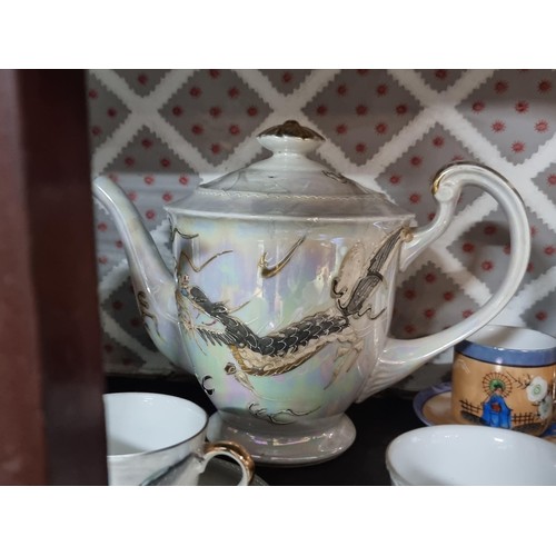 1 - A collection of 4x part oriental tea sets including a mother of pearl lustre tea set, a dragon desig... 