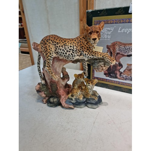 19 - 2 leopard ornaments including a boxed regency fine arts leopardess with cubs lying on a branch along... 