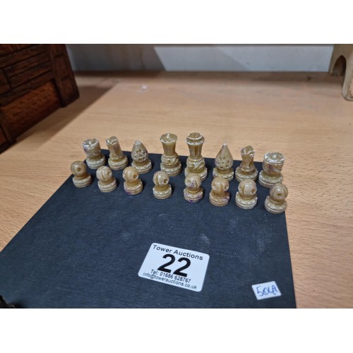 22 - A miniature set  of resin chess pieces, all  individually carved with good detailing, tallest has a ... 