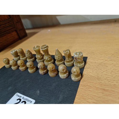 22 - A miniature set  of resin chess pieces, all  individually carved with good detailing, tallest has a ... 