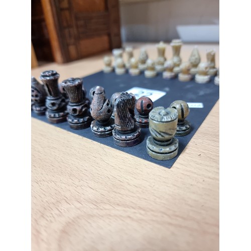 22 - A miniature set  of resin chess pieces, all  individually carved with good detailing, tallest has a ... 