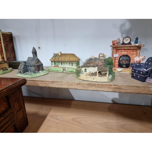 25 - 2 shelves containing a quantity of model houses and buildings by the Irish heritage collection inclu... 