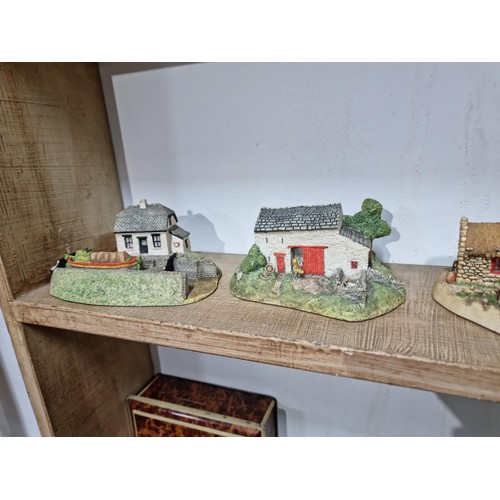 25 - 2 shelves containing a quantity of model houses and buildings by the Irish heritage collection inclu... 