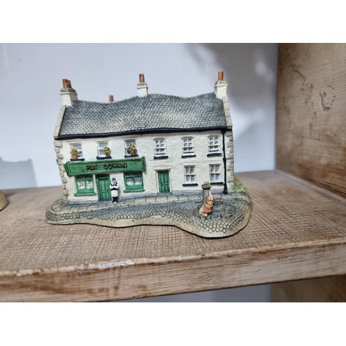 25 - 2 shelves containing a quantity of model houses and buildings by the Irish heritage collection inclu... 