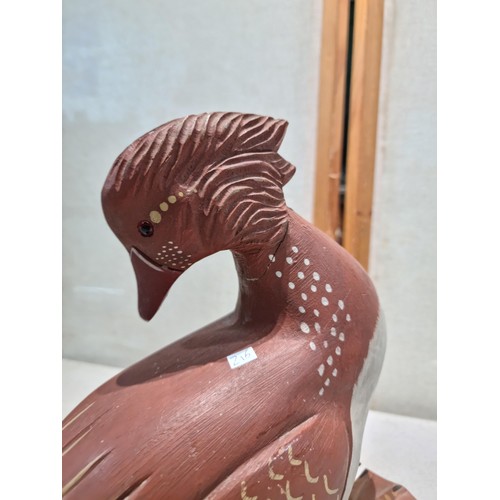 29 - A large wooden horse figure in a prancing stance along with a large wooden duck figure. Both of the ... 