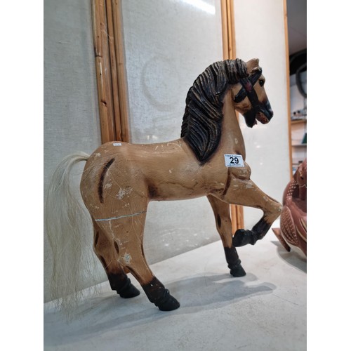 29 - A large wooden horse figure in a prancing stance along with a large wooden duck figure. Both of the ... 