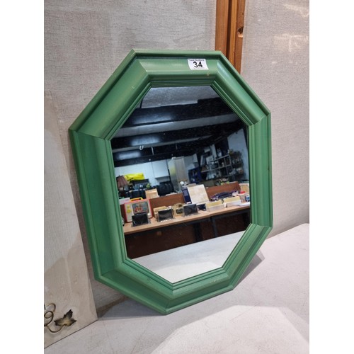 34 - 2 wooden framed mirrors, 1 with a wrought iron ivy design and 1 in an octagonal design, in green. Bo... 