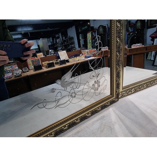 34A - 2 ornate gilt framed bevel edges mirrors, 1 with an etched floral and swallow design, both are in go... 