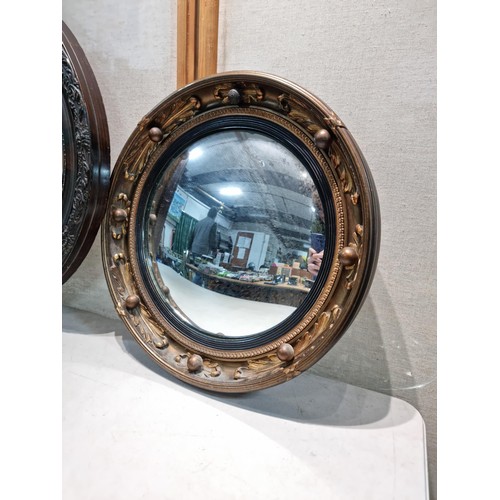 40 - 2 ornate mirrors, 1 in an oval frame with a carved edge and bevel edged along with a port hole mirro... 