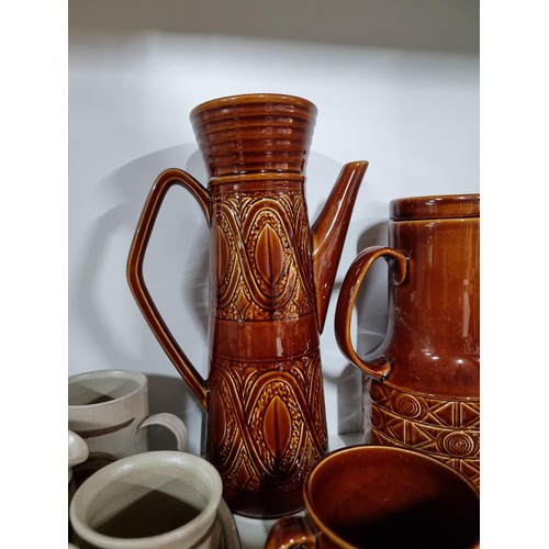 42 - Beswick Zorba coffee set with coffee pot etc along with another studio pottery earthenware coffee se... 