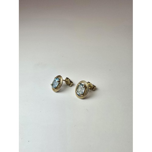 289 - A pair of stunning hallmarked 9ct yellow gold stud earrings inset with large faceted natural blue sp... 