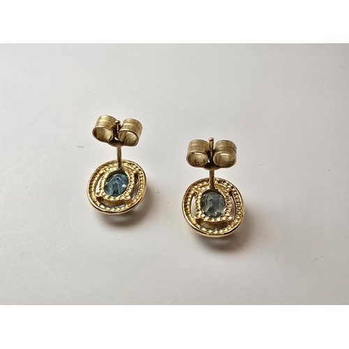 289 - A pair of stunning hallmarked 9ct yellow gold stud earrings inset with large faceted natural blue sp... 