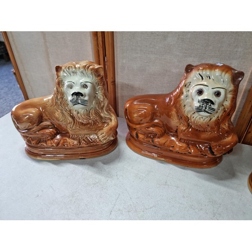 47 - 3 Staffordshire recumbent lions 1 has its glass eyes, one has replacement ears otherwise in good ord... 