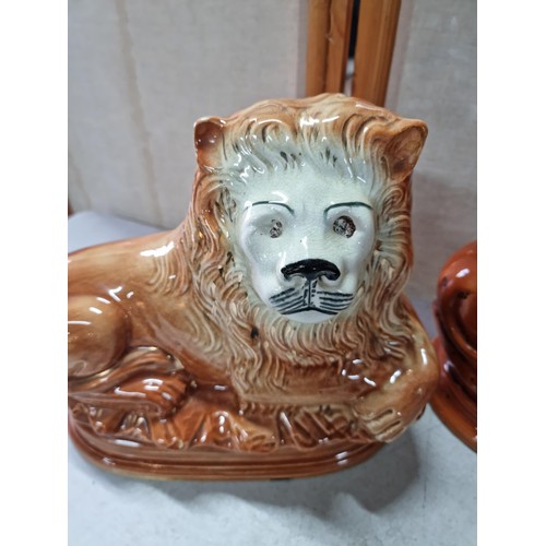 47 - 3 Staffordshire recumbent lions 1 has its glass eyes, one has replacement ears otherwise in good ord... 