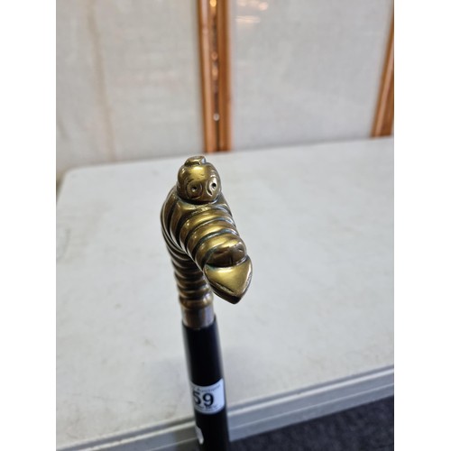 59 - An unusual Michelin walking stick with a Michelin man in a diving pose, stamped Michelin to the coll... 