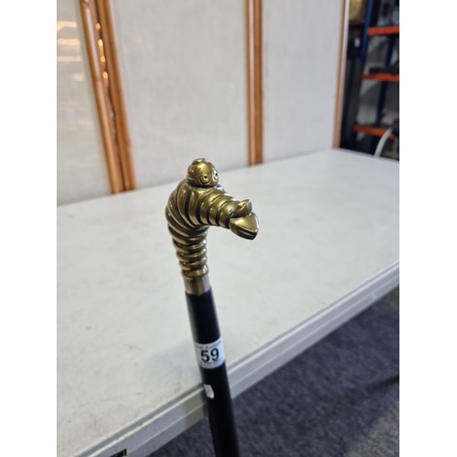 59 - An unusual Michelin walking stick with a Michelin man in a diving pose, stamped Michelin to the coll... 