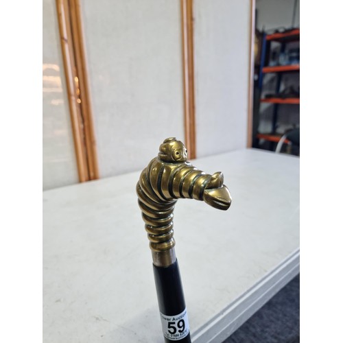 59 - An unusual Michelin walking stick with a Michelin man in a diving pose, stamped Michelin to the coll... 