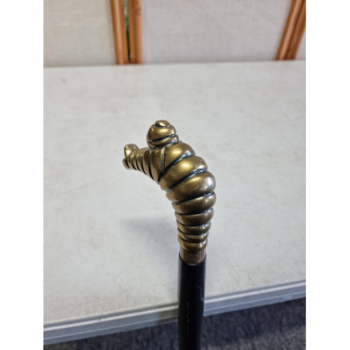 59 - An unusual Michelin walking stick with a Michelin man in a diving pose, stamped Michelin to the coll... 