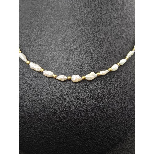 273 - A hallmarked 9ct yellow gold and natural pearl beaded necklace featuring pearl beads and 9ct gold be... 