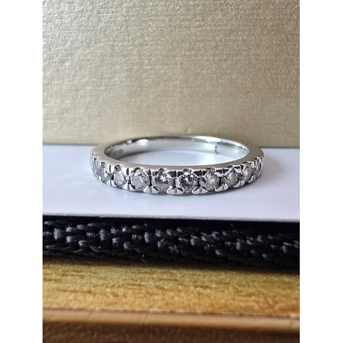 288 - A fine quality hallmarked 950 platinum diamond ring inset with 11 diamonds which are very sparkly an... 