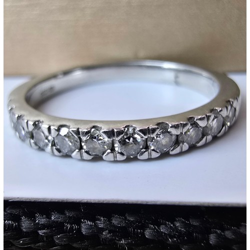 288 - A fine quality hallmarked 950 platinum diamond ring inset with 11 diamonds which are very sparkly an... 