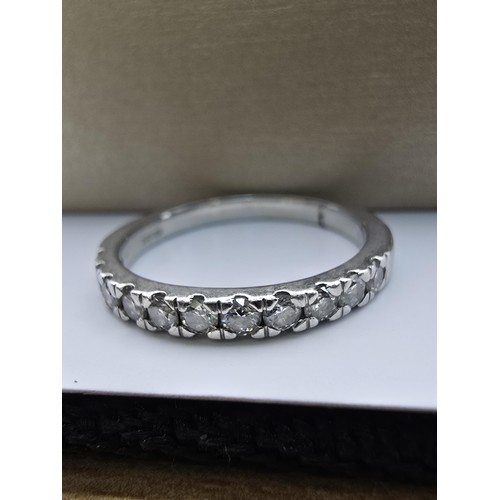 288 - A fine quality hallmarked 950 platinum diamond ring inset with 11 diamonds which are very sparkly an... 