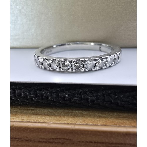 288 - A fine quality hallmarked 950 platinum diamond ring inset with 11 diamonds which are very sparkly an... 