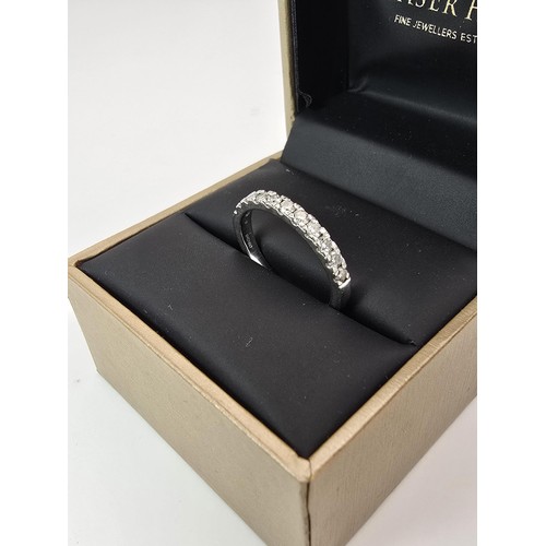 288 - A fine quality hallmarked 950 platinum diamond ring inset with 11 diamonds which are very sparkly an... 