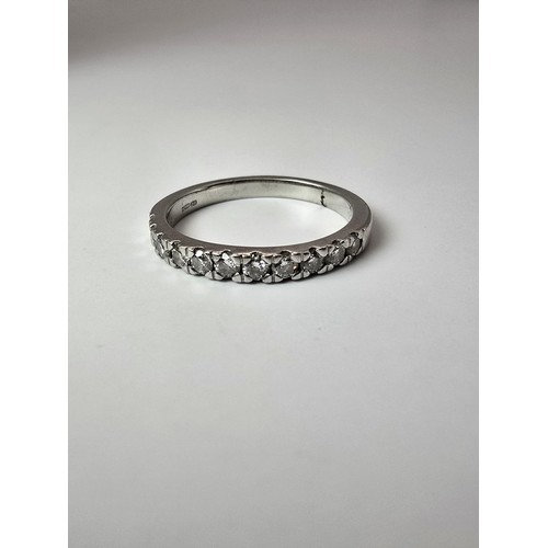 288 - A fine quality hallmarked 950 platinum diamond ring inset with 11 diamonds which are very sparkly an... 