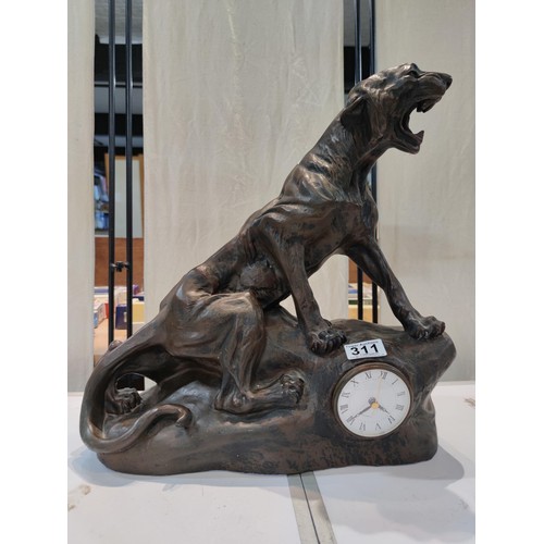 311 - A very large and impressive fibreglass figural clock in the form of a jaguar sitting on a rock featu... 