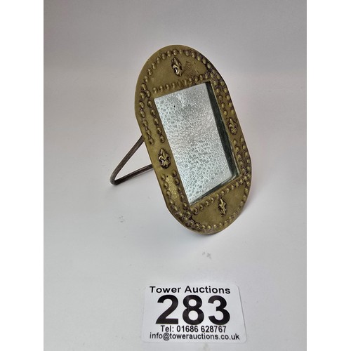 283 - An antique hand made classic Art Nouveau hand beaten brass miniature mirror. having a beaded and Fle... 