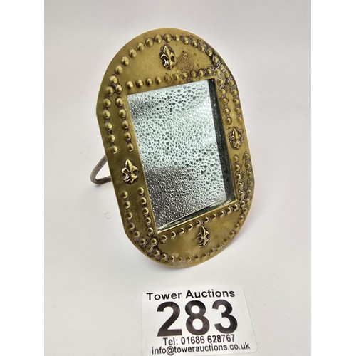 283 - An antique hand made classic Art Nouveau hand beaten brass miniature mirror. having a beaded and Fle... 