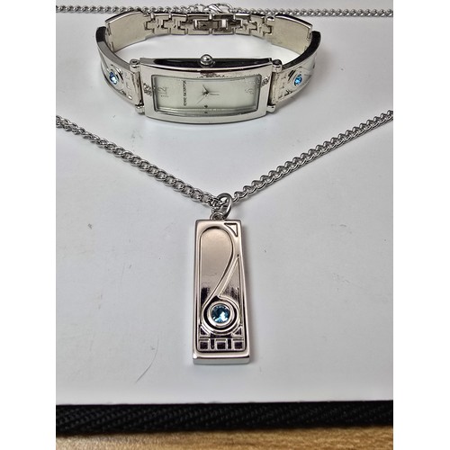 235 - An as new Rennie Mackintosh ladies quartz watch with a silvertone strap matching silvertone pendant ... 