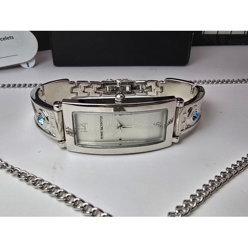 235 - An as new Rennie Mackintosh ladies quartz watch with a silvertone strap matching silvertone pendant ... 