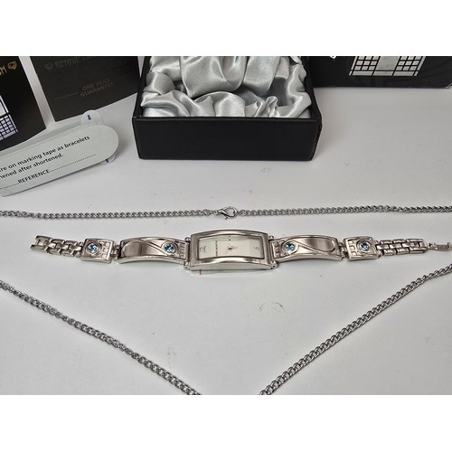 235 - An as new Rennie Mackintosh ladies quartz watch with a silvertone strap matching silvertone pendant ... 