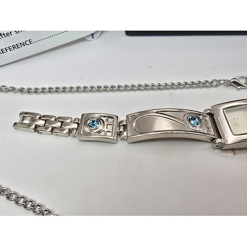 235 - An as new Rennie Mackintosh ladies quartz watch with a silvertone strap matching silvertone pendant ... 