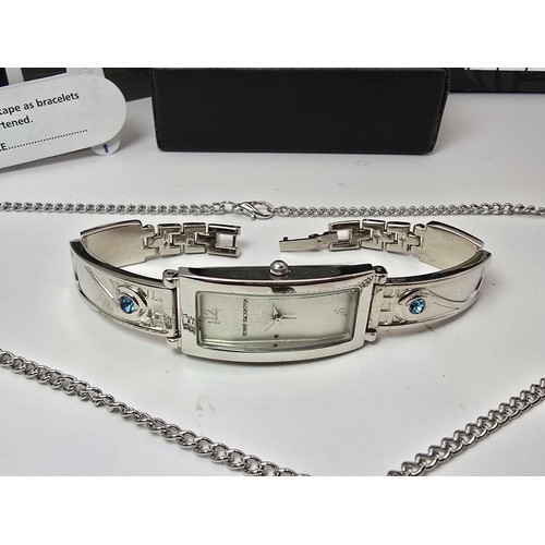 235 - An as new Rennie Mackintosh ladies quartz watch with a silvertone strap matching silvertone pendant ... 