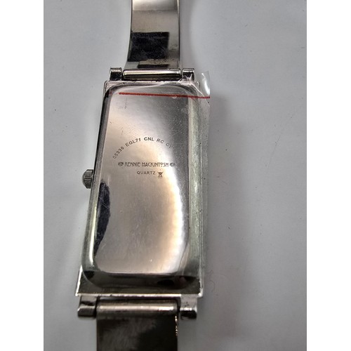 235 - An as new Rennie Mackintosh ladies quartz watch with a silvertone strap matching silvertone pendant ... 