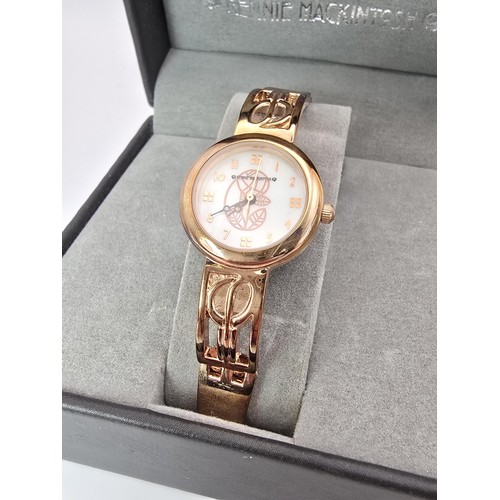 236 - An as new Rennie Mackintosh ladies quartz watch with a rose gold tone strap and case featuring a cla... 